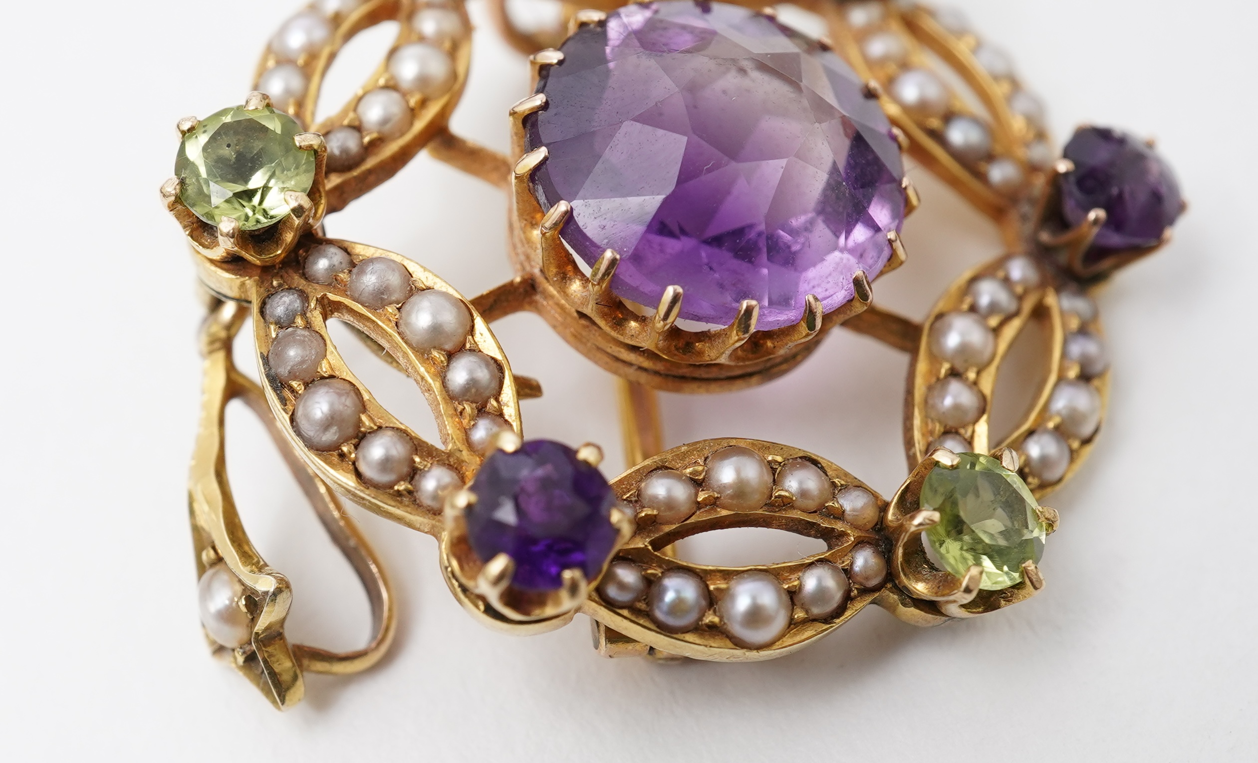 An Edwardian amethyst, chrysoberyl and seed pearl pendant/brooch, early 20th century